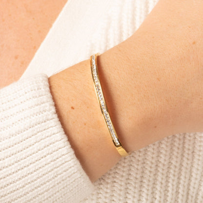 Gold hinged crystal bangle with clear stones, narrow band on wrist