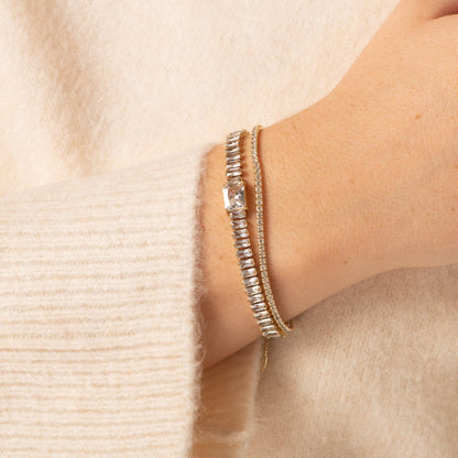 Gold adjustable tennis bracelet with pave stones, worn on wrist