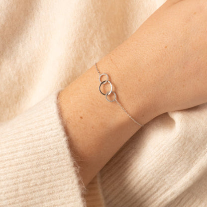 Silver chain bracelet with three linked ring charms