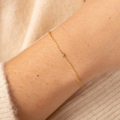 Gold CZ diamond trio bracelet close-up, three small round stones on chain