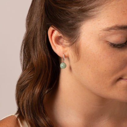 Silver-tone huggie hoop earring with pave texture and green jade drop charm