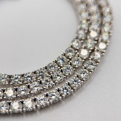 Close-up moissanite tennis necklace with prong-set round stones in silver tone