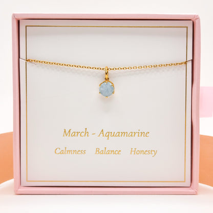 Gold necklace with round blue aquamarine pendant on fine chain