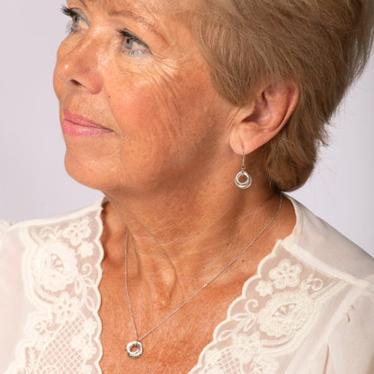 Silver ring-pendant necklace with fine chain worn on neck