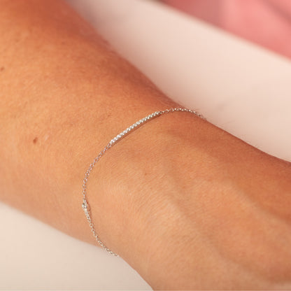 Thin silver chain bracelet with small clear stones along the band