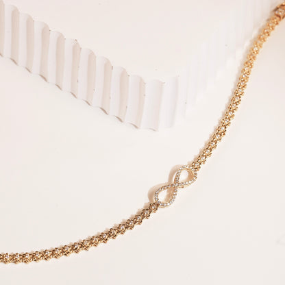 Gold pavé infinity link bracelet with linked infinity motif at center