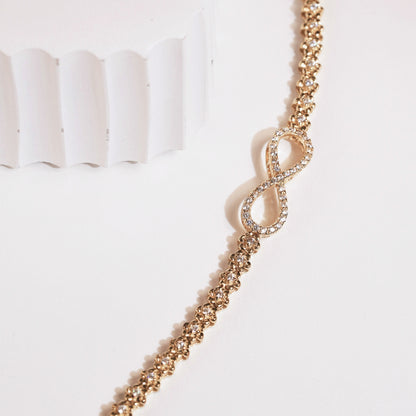 Gold pavé infinity link bracelet with heart-shaped infinity charm detail