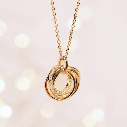 Gold-tone rings pendant necklace with linked chain and three stacked ring charms