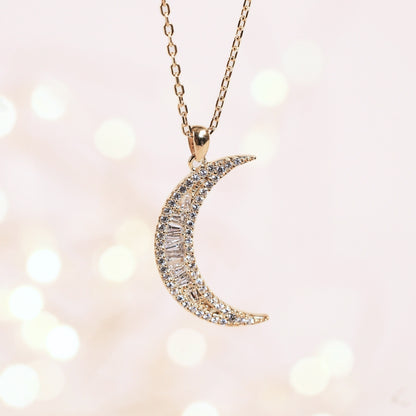 Crescent moon pendant necklace with pavé stones on a gold chain