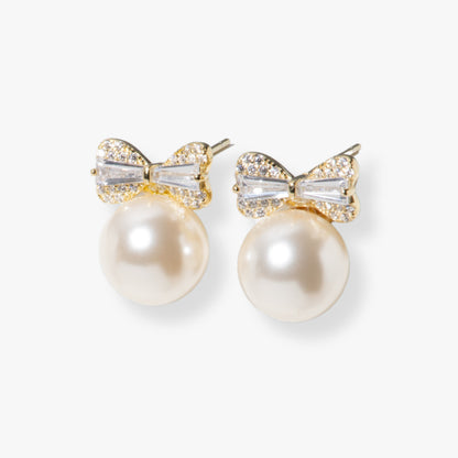 Gold-tone pearl bow stud earrings with rhinestone bow and round pearl drop