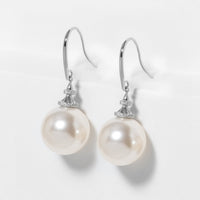 Silver pearl hook earrings with large round pearl drops and sparkling crystal caps