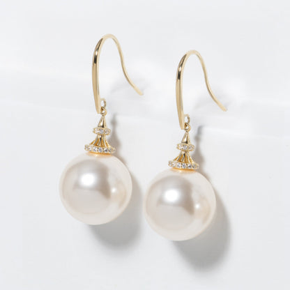 Gold pearl hook earrings with large round pearl drops and sparkling crystal caps