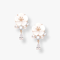 Rose gold flower earrings with white enamel petals, pearl beads, and crystal drop