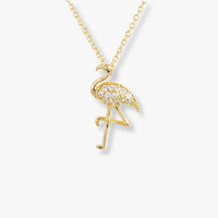 Gold-tone flamingo pendant necklace with clear stone accents and chain