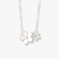 Silver flower necklace with four-petal pendant and small star charm