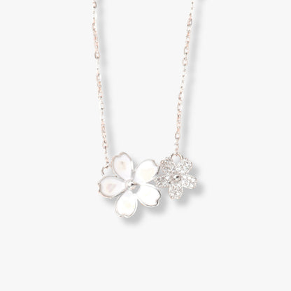 Silver flower necklace with four-petal pendant and small star charm