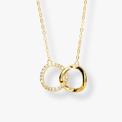 Gold-tone interlocking circles necklace with crystal accents, linked pendant