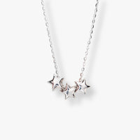 Silver three-star pendant necklace on a chain with three five-point star charms.