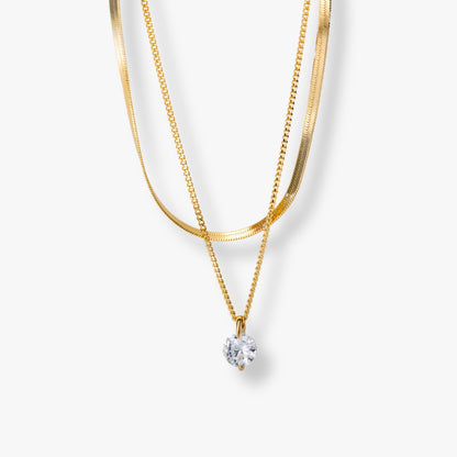 Double-layer necklace with gold-tone snake chains and round crystal pendant