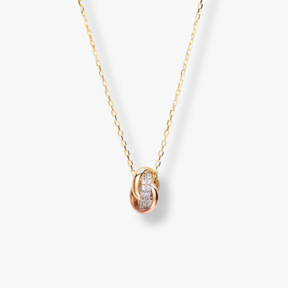 Mixed-metal knot necklace with oval pendant and pavé sparkle, gold chain