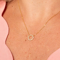 Gold circle pendant necklace with small crystal circle pendant