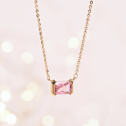 Gold-tone chain necklace with pink square faceted gemstone centerpiece