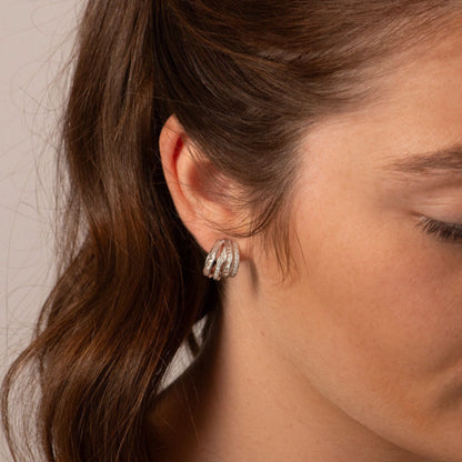 Chunky silver half hoop earrings with textured ridged crystal bands