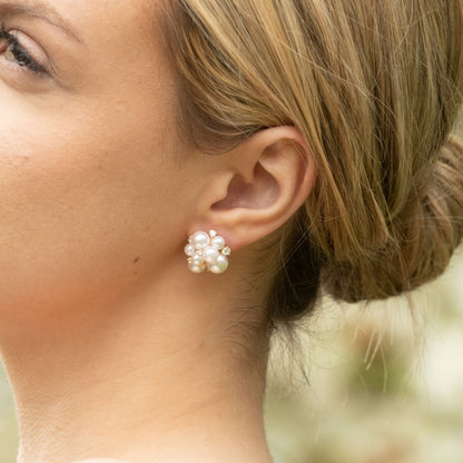 Pearl cluster stud earrings with gold-tone settings and crystal accents