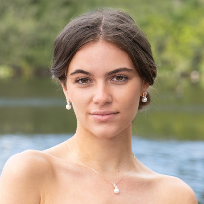 Rose gold crystal halo pearl drop earrings, shown being worn