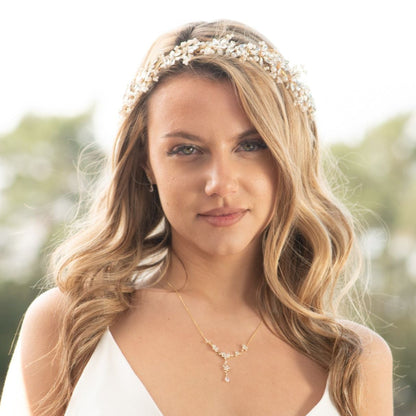 Silver bridal crystal floral necklace on model with teardrop drop pendant