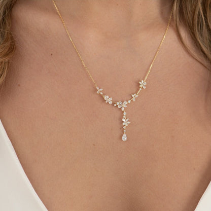 Gold bridal crystal floral necklace worn at the neckline with teardrop drop pendant