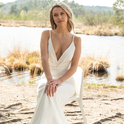 Gold crystal floral bridal necklace on model with teardrop drop pendant