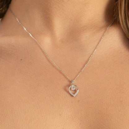 Silver teardrop diamond necklace with small teardrop pendant at neckline