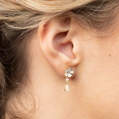 Gold-tone enamel flower drop earrings with white petals and teardrop pearl-like dangle