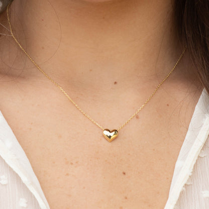 Gold heart necklace with V-shaped heart pendant on fine chain