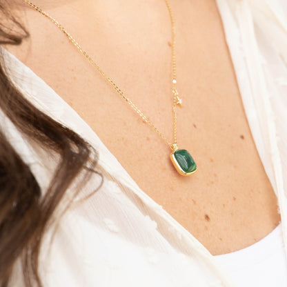 Malachite stone necklace close-up with square green pendant on gold chain