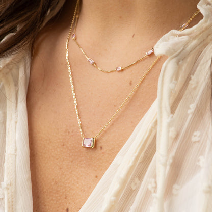 Gold-tone CZ baguette necklace with small pink rectangular stones at the neckline