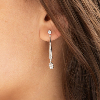 Silver CZ drop earrings on ear with two dangling teardrop stones