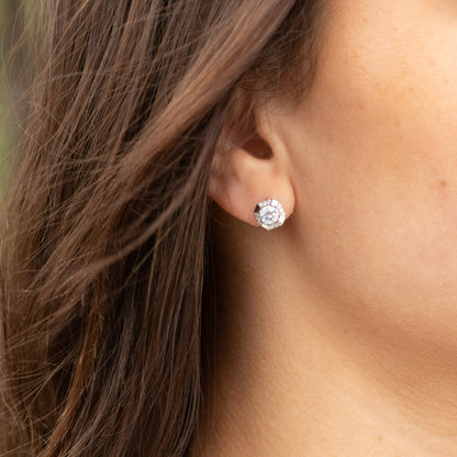 Sterling silver square stud earrings with clear round-cut center stone, side view on ear