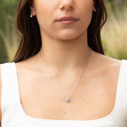 Silver square crystal pendant necklace with thin chain, worn at the collar