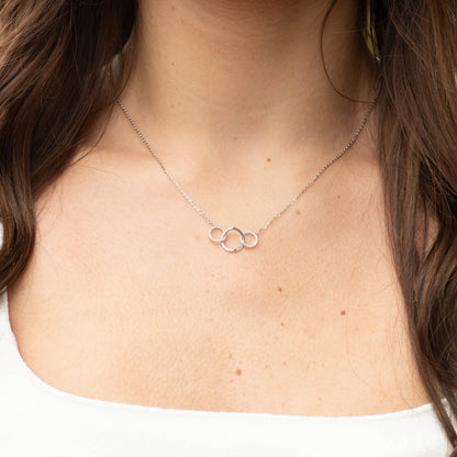 Three-ring pendant necklace on collarbone, silver-tone chain
