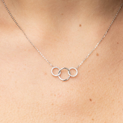 Three interlocking ring pendant necklace with light stones, silver-tone