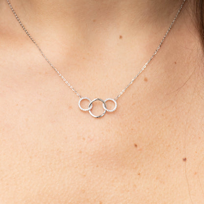 Silver 3-ring necklace with two sparkling rings and one smooth center ring charm