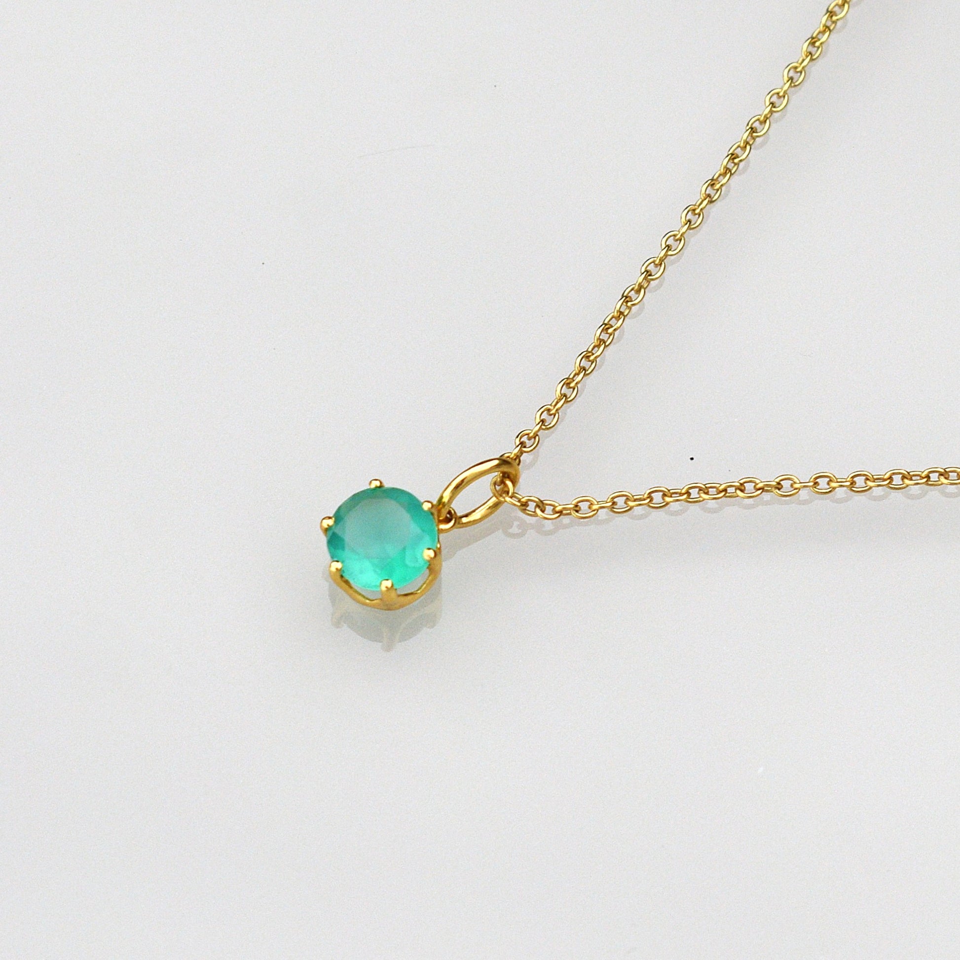 Gold-tone necklace with round green gemstone pendant and link chain