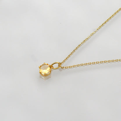 Gold-tone chain necklace with round citrine gemstone pendant on thin links