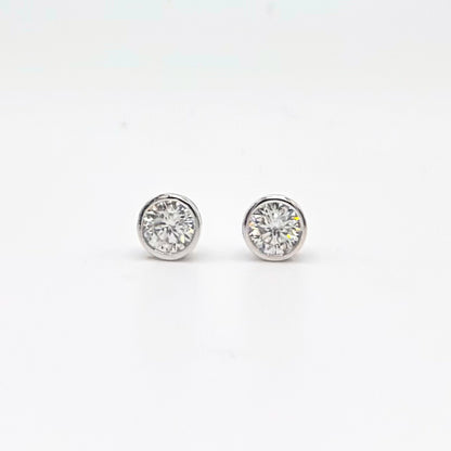 Round bezel-set moissanite stud earrings in silver-tone settings