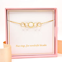 Gold-tone 5-link ring bracelet with circular crystal-like ring links