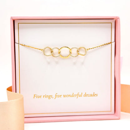 Gold-tone 5-link ring bracelet with circular crystal-like ring links