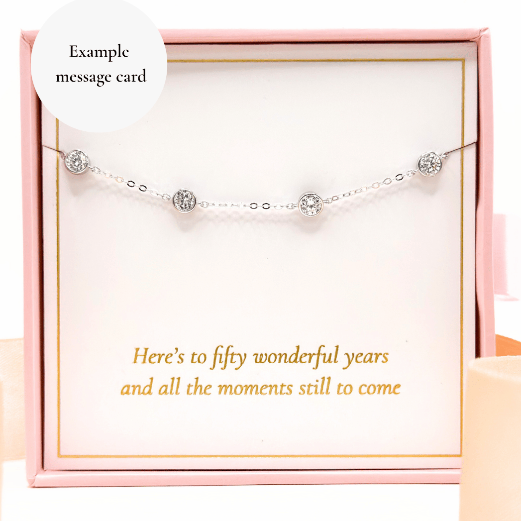 Moissanite diamond bracelet with five round prong-set stones on a delicate chain