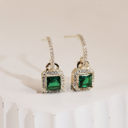 Pair of gold-tone CZ drop earrings with square green stones and pavé frames